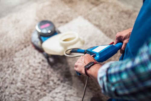 Electrostatic disinfection spray being used on a carpet for thorough sanitization.